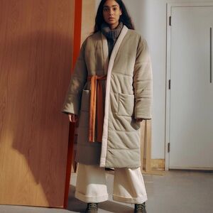 OFFHOURS homecoat in Michelangelo.      Beige Puffer Coat with Orange Belt